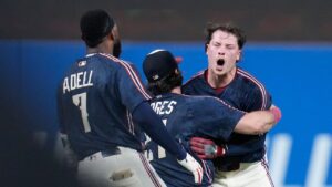 Cleveland Guardians' Travis Bazzana, right, celebrates with teammates after his game winning single in the tenth inning of the second baseball game of a split doubleheader against the Detroit Tigers in Cleveland, Friday, Sept. 4, 2026. (Sue Ogrocki/AP Photo)