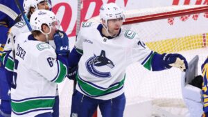 Vancouver Canucks left wing Jake Debrusk (74) celebrates his goal during the third period of an NHL hockey game against the Buffalo Sabres Tuesday, Jan. 6, 2026, in Buffalo, N.Y. (Jeffrey T. Barnes/AP Photo)