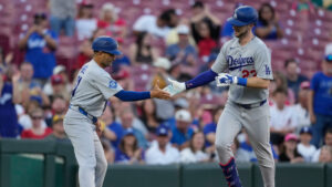 Los Angeles Dodgers right fielder Kyle Tucker, (23) celebrates with third base coach Dino Ebel (91) as he rounds third base after hitting a solo home run during the second inning of a baseball game against the Cincinnati Reds, Monday, Sept. 14, 2026, in Cincinnati. (Carolyn Kaster/AP)