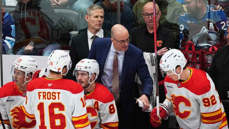Calgary Flames head coach Ryan Huska confers with right wing Matvei Gridin (92) in the first period of an NHL hockey game. (David Zalubowski/AP)