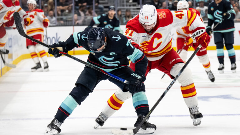 Seattle Kraken forward Jordan Eberle, left, and Calgary Flames defenseman Jake Livingstone battle for the puck during the second period of a preseason NHL hockey game, Thursday, Sept. 24, 2026, in Seattle. (Stephen Brashear/AP)