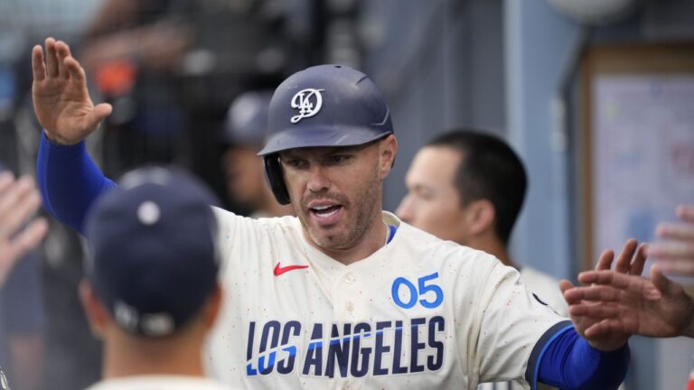 Los Angeles Dodgers' Freddie Freeman is congratulated by teammates in the dugout after scoring on a single by Teoscar Hernandez during the first inning of a baseball game against the Washington Nationals, Saturday, Sept. 5, 2026, in Los Angeles. (Mark J. Terrill/AP)