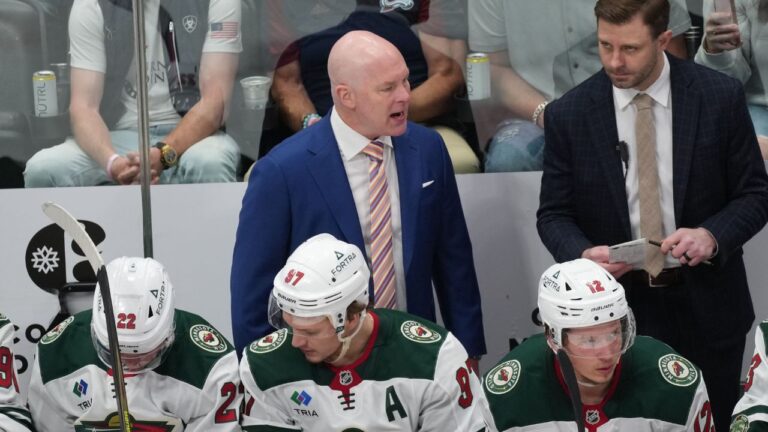 Minnesota Wild head coach John Hynes, back left, talks to players as assistant coach Patrick Dwyer, back right, looks on in the third period of Game 5 of an NHL Stanley Cup hockey second-round playoff series against the Colorado Avalanche Wednesday, May 13, 2026, in Denver. (David Zalubowski/AP)