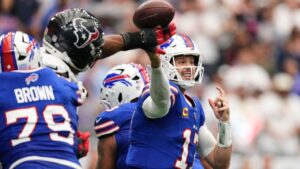 Buffalo Bills quarterback Josh Allen (17) throws an incomplete pass forced by Houston Texans defensive end Danielle Hunter, second from left, during the second half of an NFL football game, Sunday, Sept. 13, 2026, in Houston. (Ashley Landis/AP)