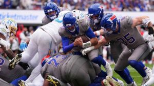 Buffalo Bills quarterback Josh Allen (17) scores on a touchdown run during the second half of an NFL football game against the Los Angeles Chargers. (Matt Rourke/AP)