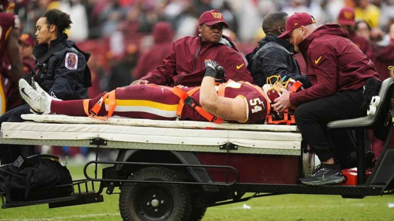 Washington Commanders linebacker Leo Chenal (54) is transported off the field by the medical team during the first half of an NFL football game against the Seattle Seahawks. (Stephanie Scarbrough/AP)