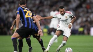 Real Madrid's Kylian Mbappe fights for the ball against Inter Milan's Hakan Calhanoglu before scoring the opening goal, during a Champions League soccer match between Real Madrid and Inter Milan in Madrid, Spain, Tuesday, Sept. 8, 2026. (Bernat Armangue/AP)