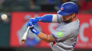 Toronto Blue Jays' Nathan Lukes hits a sacrifice flyout which scored teammate Brett Bateman during the first inning of a baseball game against the Texas Rangers, Sunday, Sept. 20, 2026, in Arlington, Texas. (LM Otero/AP)