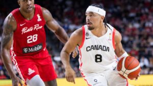 Canada's Ryan Nembhard (8) carries the ball past Puerto Rico's Ismael Romero (28) during second half FIBA World Cup qualification action in Hamilton on Friday, July 3, 2026. (Nick Iwanyshyn/CP)