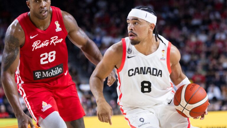 Canada's Ryan Nembhard (8) carries the ball past Puerto Rico's Ismael Romero (28) during second half FIBA World Cup qualification action in Hamilton on Friday, July 3, 2026. (Nick Iwanyshyn/CP)