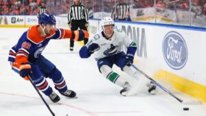 Edmonton Oilers' Jake Walman (96) defends against Vancouver Canucks' Tom Willander (5) during first period NHL hockey action in Edmonton on Tuesday, Sept. 29, 2026. (Codie McLachlan/THE CANADIAN PRESS)