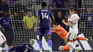 Orlando City forward Antoine Griezmann (7) scores a goal past Toronto FC goalkeeper Luka Gavran, second from right, during the first half of an MLS soccer match. (Phelan M. Ebenhack/AP)