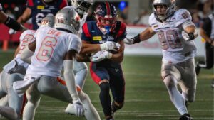 Montreal Alouettes Tyson Philpot, centre, attempts to rush through the B.C. Lions defence during first half CFL football action in Montreal, Friday, Sept. 4, 2026. (Peter McCabe/THE CANADIAN PRESS)