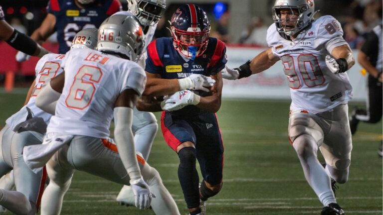 Montreal Alouettes Tyson Philpot, centre, attempts to rush through the B.C. Lions defence during first half CFL football action in Montreal, Friday, Sept. 4, 2026. (Peter McCabe/THE CANADIAN PRESS)