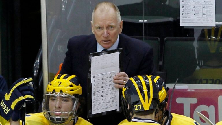 In this March 20, 2014, file photo, Michigan head coach Red Berenson, top, talks with players during the first period of an NCAA Big Ten college hockey game against Penn State, in St. Paul, Minn. (Ann Heisenfelt/AP)