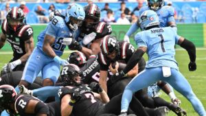 Ottawa Redblacks quarterback Bryson Barnes, centre, scores a touchdown against the Toronto Argonauts during first half CFL football action in Toronto. (Jon Blacker/THE CANADIAN PRESS)