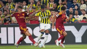 Fenerbahce's Archie Brown, centre, challenges for the ball with Roma's Gianluca Mancini, left, and Roma's Devyne Rensch during the Champions League opening phase soccer match between Fenerbahce and Roma in Istanbul, Turkey, Thursday, Sept. 10, 2026. (Khalil Hamra/AP)