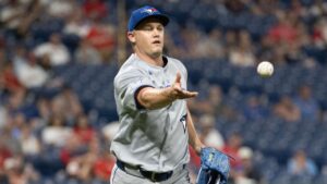 Toronto Blue Jays relief pitcher Paul Sewald tosses the ball to first base to get Cleveland Guardians' Jo Adell out during the sixth inning of a baseball game, Wednesday, Sep. 2, 2026, in Cleveland. (Phil Long/AP Photo)