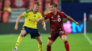 Toronto FC's Jackson Gilman (right) shields the ball form Nashville SC's Sam Surridge (9) during first half MLS action in Toronto, on Wednesday, Sept. 9, 2026. (Keito Newman/THE CANADIAN PRESS)
