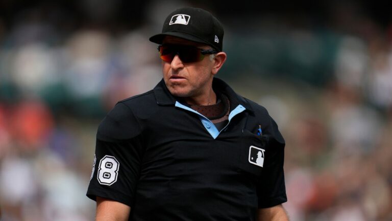 Home plate umpire Chris Guccione looks to the Los Angeles Dodgers dugout during the ninth inning of a baseball game against the Detroit Tigers Saturday, Aug. 29, 2026, in Detroit. (Paul Sancya/AP)
