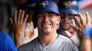 Toronto Blue Jays' Brandon Valenzuela gets high fives in the dugout after scoring in the fifth inning of a baseball game against the Cleveland Guardians in Cleveland, Thursday, Sept. 3, 2026. (Sue Ogrocki/AP Photo)