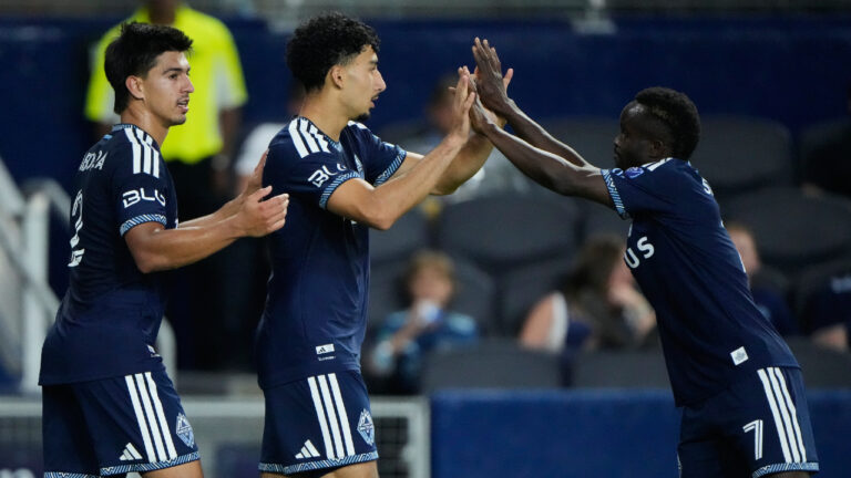 Vancouver Whitecaps' Rayan Elloumi, center, celebrates with Mathias Laborda, left, and Cheikh Sabaly (7) after scoring a goal during the second half of an MLS soccer match against Sporting Kansas City, Saturday, Aug. 29, 2026, in Kansas City, Kan. (Charlie Riedel/AP)