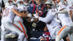 Montreal Alouettes quarterback Terry Wilson (14) fights to get through the B.C. Lions defence during second half CFL football action in Montreal, Friday, Sept. 4, 2026. (Peter McCabe/THE CANADIAN PRESS)