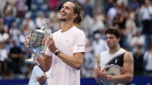 Alexander Zverev, of Germany, left, poses with the trophy after he won the men's singles final of the U.S. Open tennis championships against Ben Shelton, of the United States, Sunday, Sept. 13, 2026, in New York. (Adam Hunger/AP)
