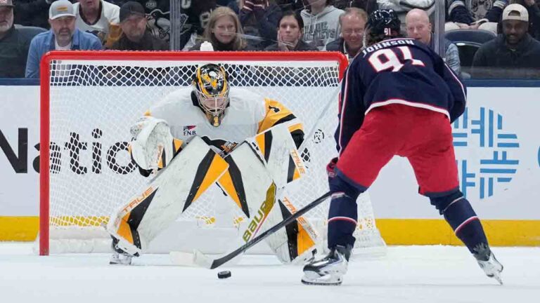 Columbus Blue Jackets center Kent Johnson (91) scores on Pittsburgh Penguins goaltender Sergei Murashov (1) in a shootout in an NHL hockey game in Columbus, Ohio, Friday, Oct. 9, 2026. (Sue Ogrocki/AP)