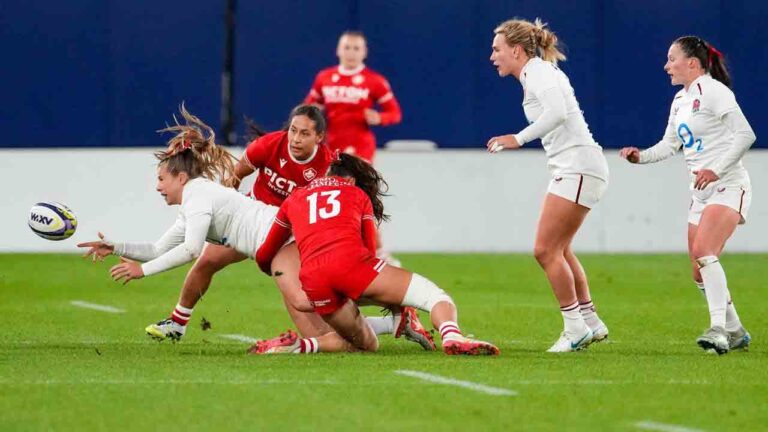 England's Zoe Harrison (left) is tackled by Canada's Florence Symonds (13) during first half women's rugby action in Toronto on Oct. 16, 2026. (Arlyn McAdorey/CP)