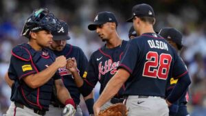 Atlanta Braves starting pitcher Ray Kerr, center, bumps fists with catcher Drake Baldwin as he exits during the third inning of Game 2 of a National League Division Series baseball game against the Los Angeles Dodgers Sunday, Oct. 4, 2026, in Los Angeles. (Mark J. Terrill/AP)