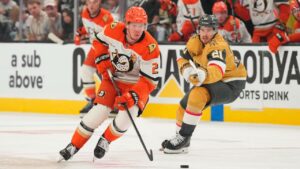 Anaheim Ducks defenseman Jackson LaCombe (2) skates with the puck against the Vegas Golden Knights during the third period of Game 5 of a second-round NHL hockey Stanley Cup playoff series Tuesday, May 12, 2026, in Las Vegas. (Candice Ward/AP)