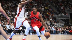 Toronto Raptors; RJ Barrett, right, drives past Miami Heat's Bam Adebayo, left, during NBA preseason basketball action in Quebec City, Saturday, Oct. 3, 2026. (Jacques Boissinot/CP)