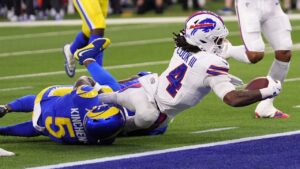 Buffalo Bills running back James Cook III, right, scores a touchdown as Los Angeles Rams safety Kamren Kinchens tackles him during the first half of an NFL football game, Monday, Oct. 12, 2026, in Inglewood, Calif. (Gregory Bull/AP)