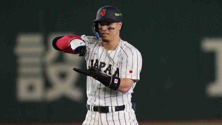 Japan's Teruaki Sato reacts after hitting a double during the eighth inning of a World Baseball Classic game between Japan and Australia on Sunday, March 8, 2026 in Tokyo. (Hiro Komae/AP)