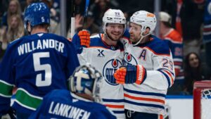 Edmonton Oilers' Vasily Podkolzin (92) is congratulated by teammate Leon Draisaitl (29) after scoring a goal on Vancouver Canucks goalie Kevin Lankinen (32) during first period NHL hockey action in Vancouver, B.C., on Thursday, Oct. 1, 2026. (Rich Lam/CP)