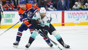 Edmonton Oilers' Connor McDavid (97) battles against Seattle Kraken's Matty Beniers (10) during first period NHL hockey action in Edmonton on Saturday, Oct. 3, 2026. THE CANADIAN PRESS/Codie McLachlan