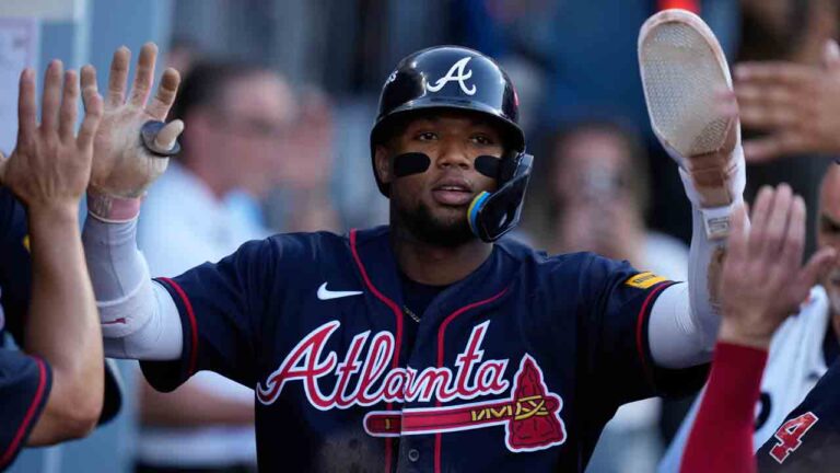 Atlanta Braves' Ronald Acuña Jr. celebrates with teammates after scoring off an RBI single by Mauricio Dubón during the first inning of Game 2 of a National League Division Series baseball game against the Los Angeles Dodgers Sunday, Oct. 4, 2026, in Los Angeles. (Mark J. Terrill/AP)