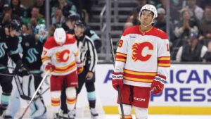 Calgary Flames defenseman Zayne Parekh (19) skates off after a stop in play during the third period of an NHL hockey game against the Seattle Kraken Sunday, Oct. 4, 2026, in Seattle. (Jason Redmond/AP)