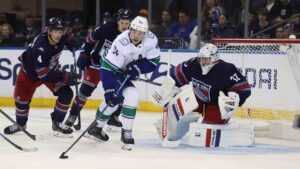 Vancouver Canucks' Linus Karlsson (94) skates with the puck against New York Rangers' Dylan Garand (33) during the second period of an NHL hockey game Sunday, Oct. 11, 2026, in New York. (Pamela Smith/AP)