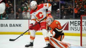 Calgary Flames center Yegor Sharangovich (17) vies for the puck against Anaheim Ducks goaltender Lukas Dostal (1) during the first period of an NHL hockey game, Tuesday, Oct. 13, 2026, in Anaheim, Calif. (Kyusung Gong/AP)