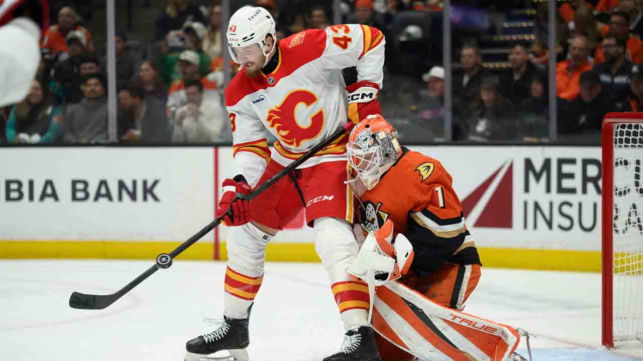 Flames break tie late, beat Ducks for first win