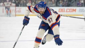 Edmonton Oilers center Connor McDavid (97), left, skates past Los Angeles Kings defenseman Mikey Anderson (44), right, with the puck during the first period of an NHL hockey game Tuesday, Oct. 13, 2026, in Los Angeles. (Caroline Brehman/AP)