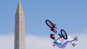 FILE - Anthony Jeanjean, of France, performs a trick, with the Luxor Obelisk of La Concorde square in the background, during the cycling BMX freestyle men's park final at the 2024 Summer Olympics, Wednesday, July 31, 2024, in Paris, France. (AP Photo/Frank Franklin II, File)