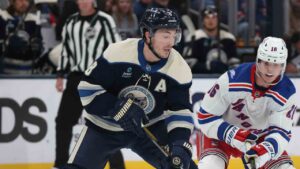 Columbus Blue Jackets defenseman Zach Werenski, left, passes the puck in front of New York Rangers forward Pavel Dorofeyev during the first period of a NHL hockey game in Columbus, Ohio, Saturday, Oct. 17, 2026. (Paul Vernon/AP)