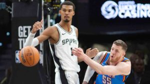 Oklahoma City Thunder center Isaiah Hartenstein (55) passes as he is guarded by San Antonio Spurs center Victor Wembanyama during the first half of an NBA basketball game, Tuesday, Oct. 20, 2026, in San Antonio. (Darren Abate/AP)