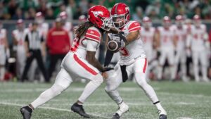 Calgary Stampeders quarterback Vernon Adams Jr. (3) hands the ball off to Deonta McMahon (20) during first half CFL football action against the Saskatchewan Roughriders in Regina on Friday, Oct. 2, 2026. (Kayle Neis/CP)