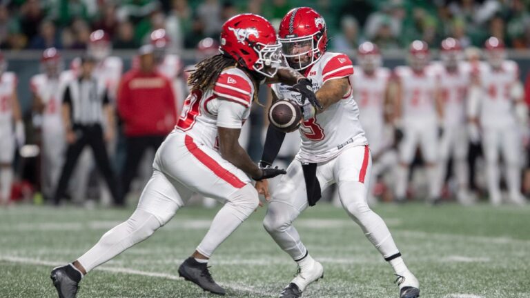 Calgary Stampeders quarterback Vernon Adams Jr. (3) hands the ball off to Deonta McMahon (20) during first half CFL football action against the Saskatchewan Roughriders in Regina on Friday, Oct. 2, 2026. (Kayle Neis/CP)