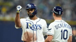 Tampa Bay Rays' Junior Caminero celebrates after hitting a single as first base coach Corey Dickerson (10) watches during the third inning in Game 2 of an American League Division Series baseball game against the New York Yankees Monday, Oct. 5, 2026, in St. Petersburg, Fla. (Chris O'Meara/AP)