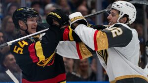 Vancouver Canucks’ Aatu Raty (54) and Las Vegas Golden Knights’ Braeden Bowman (42) push and shove after the whistle during third period NHL hockey action in Vancouver, Sunday, Oct. 4, 2026. (Rich Lam/CP)